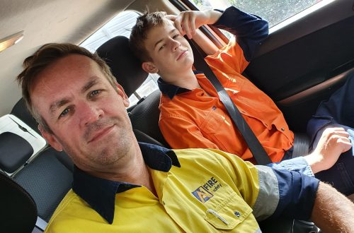 Father and son sitting inside a vehicle, representing the family-owned A1 Fire and Safety business.